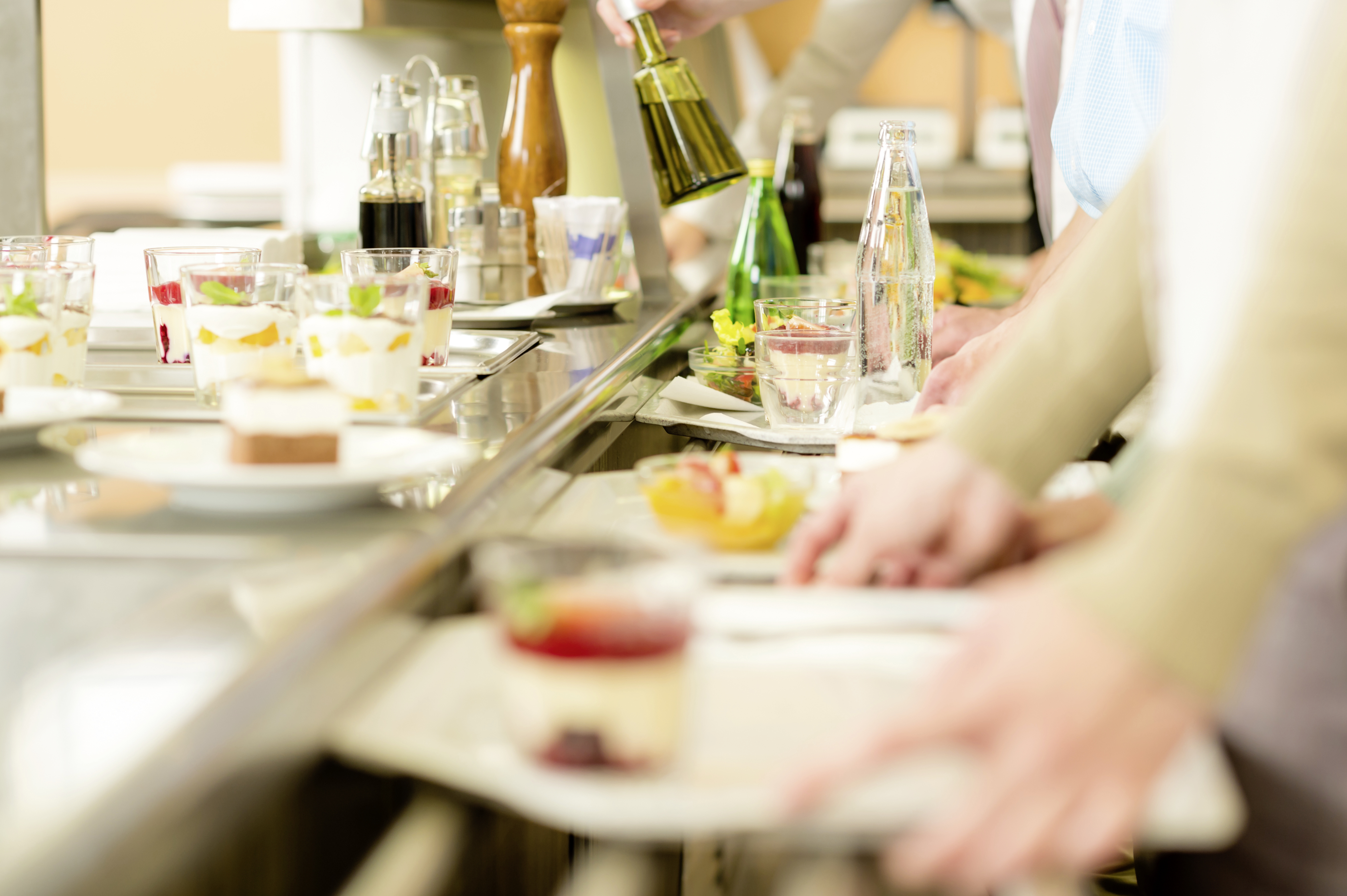 Desserts at cafeteria people with serving tray self service canteen