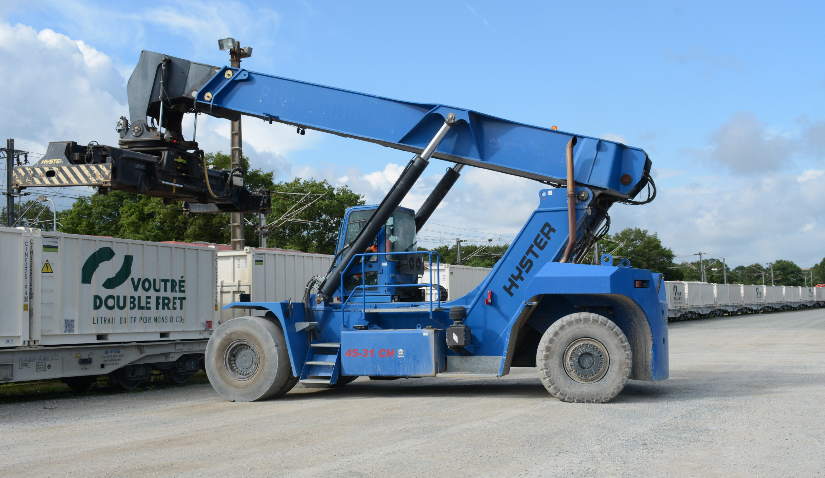 Dans sa carrière de Voutré, les Carrières de l'Ouest utilisent un chariot porte-conteneur pour manipuler des caisses acheminées par train. Crédit : CDF