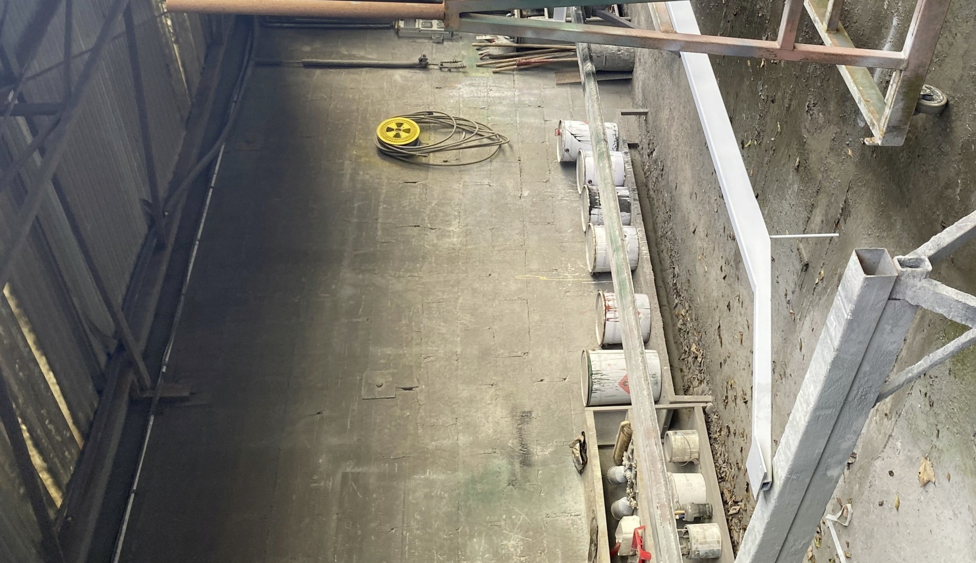 La peinture liquide est appliquée sous un toit dans la cour. 